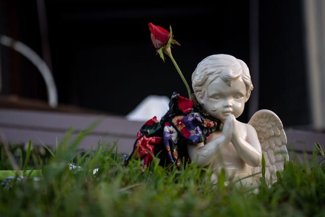 A small angel figurine sits up right in front of a heavily damaged self storage facility in Waverly, Tenn., on Sunday, Aug. 22, 2021. 
