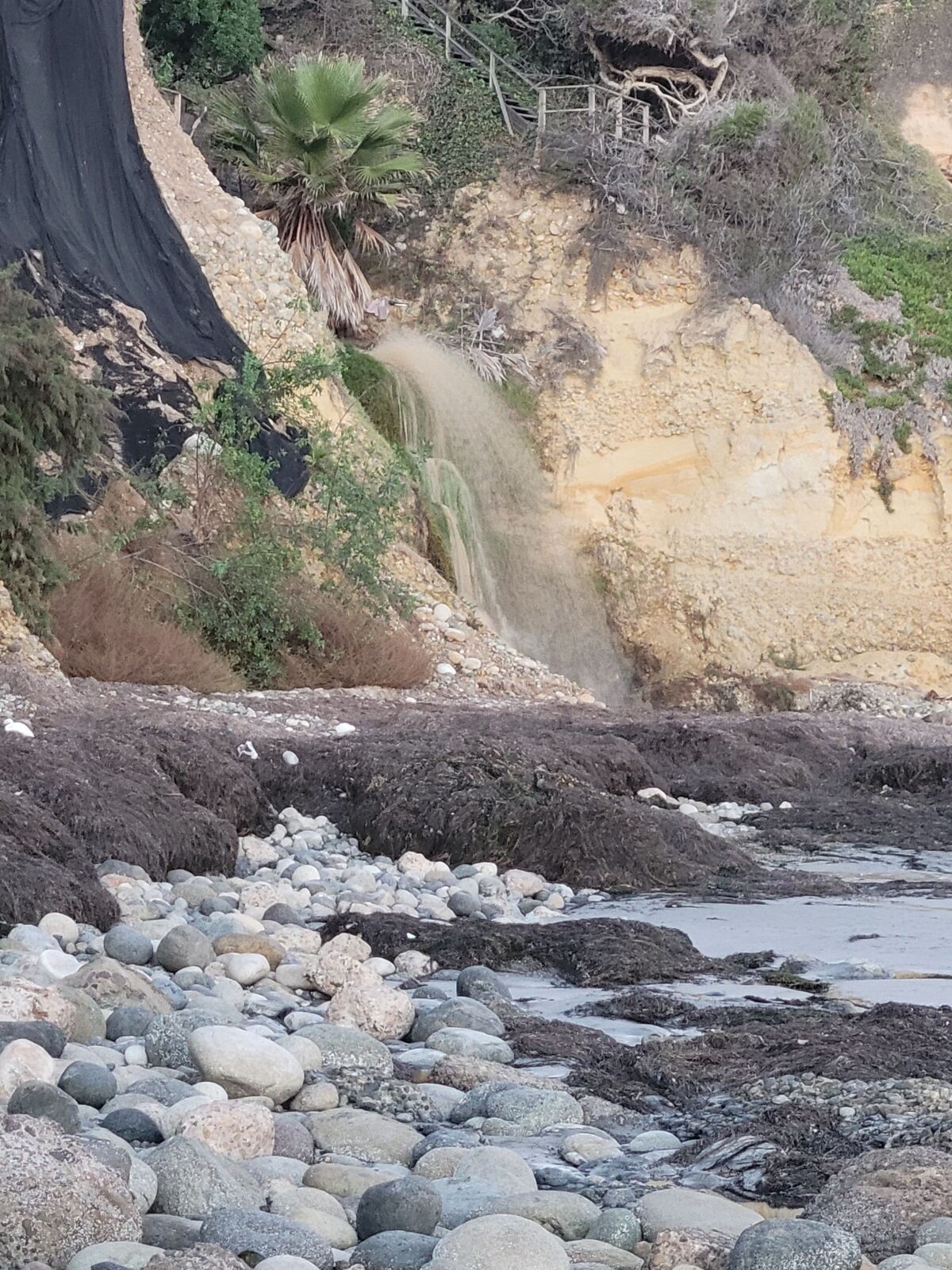 Water flows from a storm drain and into the ocean near Bird Rock after a water main break Oct. 24.