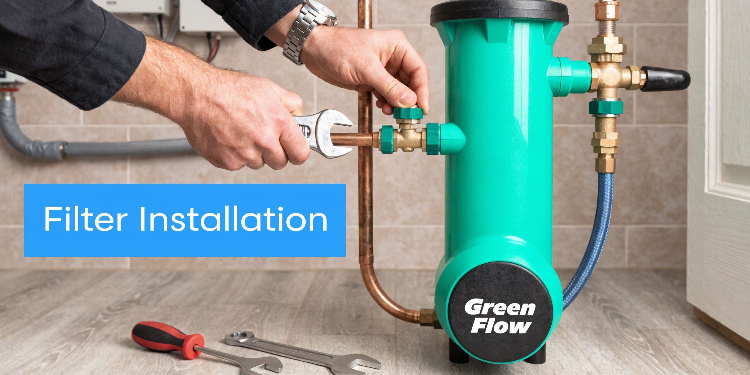 A professional technician using a wrench to install a Green Flow water filtration system for home use.