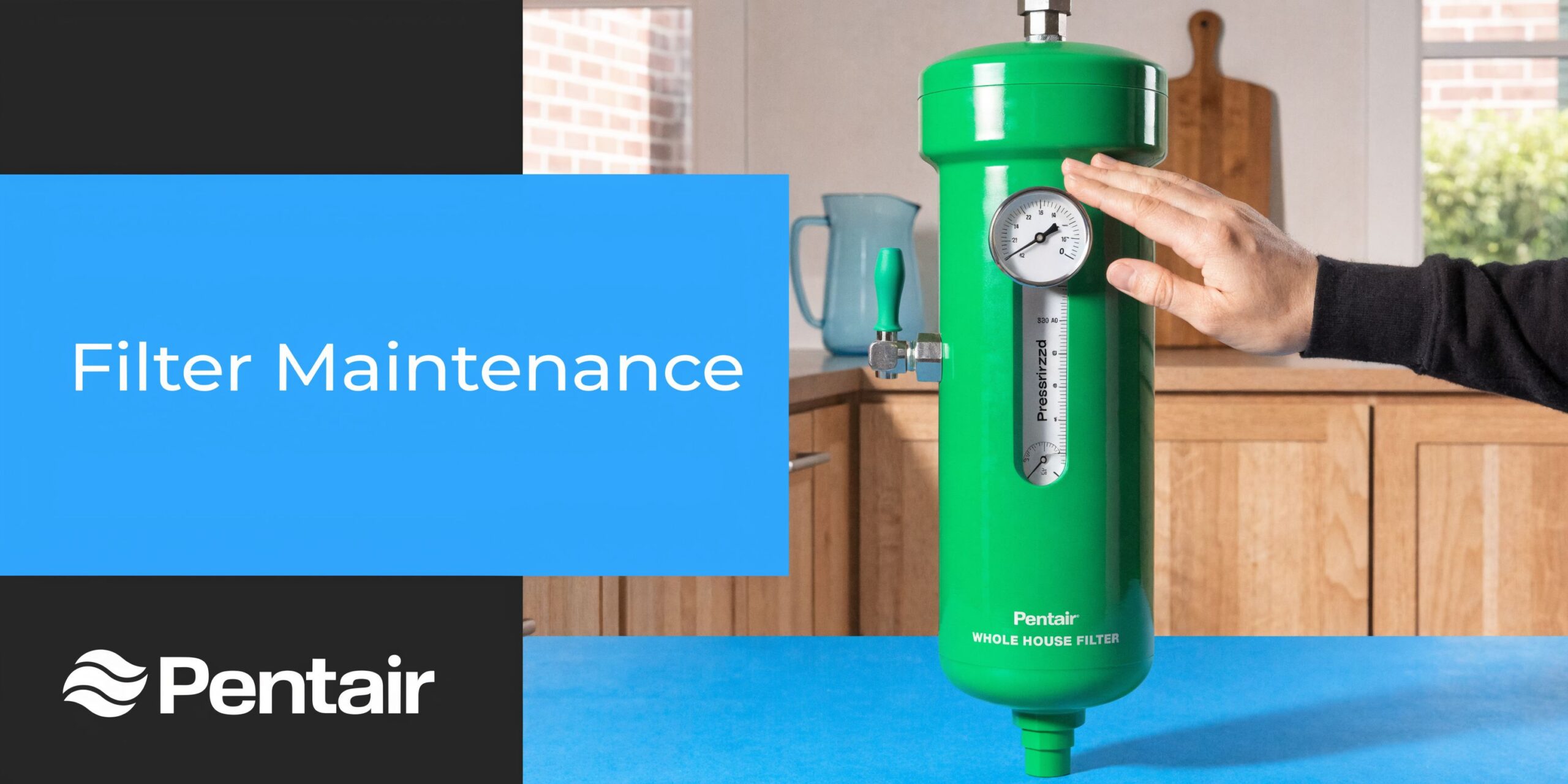 A person checking the pressure gauge on a green Pentair whole house water filtration system unit.
