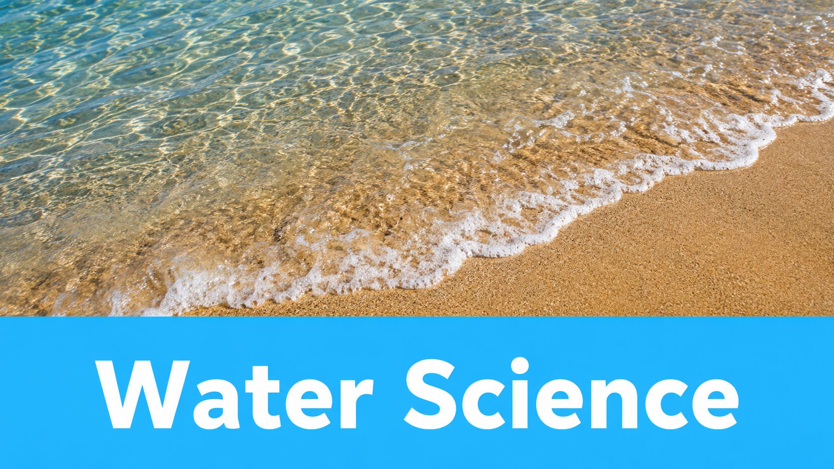 Clear ocean water gently lapping onto a sandy beach under bright sunny daylight conditions