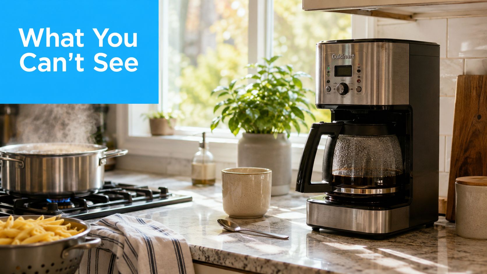A modern kitchen counter with a coffee maker, a mug, and a pot of boiling water.