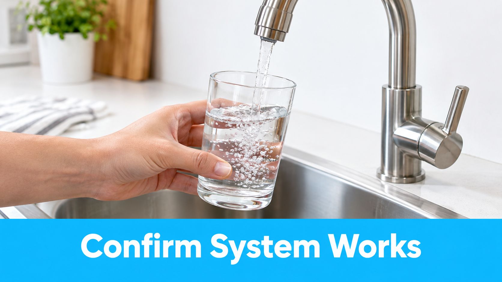 A person holding a glass while filling it with clear water from a modern kitchen sink faucet.